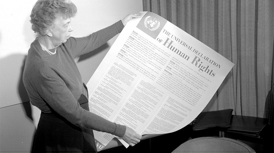 Eleanor Roosevelt holding a Universal Declaration of Human Rights poster.